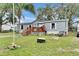 Charming single-story home with light blue siding, a cozy front porch, and a well-maintained lawn at 4854 Myrtle View N Dr, Mulberry, FL 33860