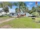 Charming single-story home with light blue siding, a cozy front porch, and a well-maintained lawn at dusk at 4854 Myrtle View N Dr, Mulberry, FL 33860
