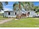 Charming single-story home with light blue siding, a cozy front porch, and a well-maintained lawn at 4854 Myrtle View N Dr, Mulberry, FL 33860