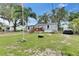 Charming single-story home with light blue siding, a cozy front porch, and a well-maintained lawn at 4854 Myrtle View N Dr, Mulberry, FL 33860