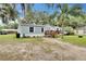Charming single-story home with light blue siding, a cozy front porch, and a well-maintained lawn at 4854 Myrtle View N Dr, Mulberry, FL 33860