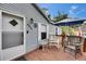 Cozy front porch with rocking chair and table, shaded by a blue umbrella for relaxation at 4854 Myrtle View N Dr, Mulberry, FL 33860