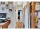Inviting hallway with neutral paint, laminate flooring, and a charming grandfather clock at 4854 Myrtle View N Dr, Mulberry, FL 33860