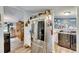 Open kitchen featuring stainless steel refrigerator, wooden cabinets, and a laundry room at 4854 Myrtle View N Dr, Mulberry, FL 33860