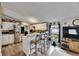 Bright kitchen with counter seating and stainless steel appliances flows into a large living area at 4854 Myrtle View N Dr, Mulberry, FL 33860