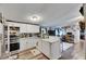 Well-lit kitchen with stainless steel appliances, white cabinetry, and an adjoining living space at 4854 Myrtle View N Dr, Mulberry, FL 33860