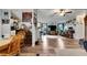 Open-concept living and dining area with wood flooring, a ceiling fan, and ample natural light at 4854 Myrtle View N Dr, Mulberry, FL 33860