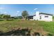 Spacious backyard with room to entertain with partially covered patio and mature trees at 5316 Dorman Rd, Lakeland, FL 33813