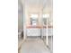 Bathroom featuring double sinks with white cabinets and mirrored closet doors at 5316 Dorman Rd, Lakeland, FL 33813