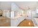 Bright eat-in kitchen features white cabinetry, wood-look flooring, and an open layout to the adjacent living area at 5316 Dorman Rd, Lakeland, FL 33813