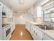 Updated kitchen features sleek countertops, white cabinetry, and stainless steel sink, creating a functional cooking space at 5316 Dorman Rd, Lakeland, FL 33813