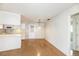 A combined kitchen and dining area are shown with light wood floors and classic hanging light fixtures at 5316 Dorman Rd, Lakeland, FL 33813