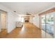 Spacious living room with stone fireplace, ceiling fan, slider to screened porch, and light wood floors at 5316 Dorman Rd, Lakeland, FL 33813