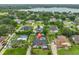 Aerial view of the property surrounded by lush landscaping and a nearby lake at 1034 Brighton Way, Lakeland, FL 33813