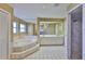 Spacious bathroom featuring a large soaking tub, double vanity, and separate tiled shower at 1034 Brighton Way, Lakeland, FL 33813