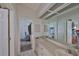 Shared bathroom with double vanity, decorative wallpaper and mirrored wall at 1034 Brighton Way, Lakeland, FL 33813