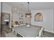 Dining room featuring modern chandelier, wood floors, and view to living room at 1034 Brighton Way, Lakeland, FL 33813