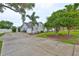 Charming single story home featuring mature landscaping, attached garage, and a long driveway at 1034 Brighton Way, Lakeland, FL 33813