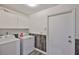 Laundry room featuring a washer, dryer and storage cabinets, offering convenience and functionality at 1034 Brighton Way, Lakeland, FL 33813