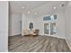 Bright living room with wood floors, French doors, and transom window at 1034 Brighton Way, Lakeland, FL 33813