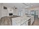 Open concept living room with kitchen island and fireplace at 1034 Brighton Way, Lakeland, FL 33813