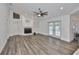 Open-concept living room with fireplace, built-ins, and French door access to pool at 1034 Brighton Way, Lakeland, FL 33813