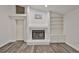 Bright living room featuring a fireplace with a 'Home Sweet Home' sign above it and built-in shelving at 1034 Brighton Way, Lakeland, FL 33813