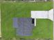 Aerial view of the property showcasing the home's layout, lush green lawn, and long driveway at 5969 Nw 65Th St, Ocala,, FL 34482