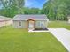 Charming single-story home featuring a cozy front porch, fresh landscaping, and a well-manicured lawn at 5969 Nw 65Th St, Ocala,, FL 34482