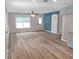 Bright living space with light laminate flooring and a barn door giving character to the room at 5969 Nw 65Th St, Ocala,, FL 34482