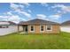 Well-manicured backyard with privacy fence, a covered patio, and lush green lawn at , Kissimmee, FL 34758