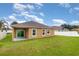 Well-maintained backyard featuring a white fence, grassy area and covered patio at , Kissimmee, FL 34758