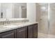 Bathroom featuring double vanity sinks with granite countertops and glass enclosed shower at , Kissimmee, FL 34758