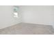 Bedroom featuring carpeted floors, base molding, and a large window at , Kissimmee, FL 34758