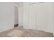 Empty bedroom featuring neutral paint and plush carpet with a closet with bi-fold doors at , Kissimmee, FL 34758