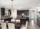 Well-equipped kitchen with stainless steel appliances, dark cabinetry, and an island for cooking and dining at , Kissimmee, FL 34758