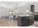 Open kitchen features an island with granite countertops, stainless appliances, and ample cabinet space at , Kissimmee, FL 34758