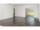Spacious living room with hardwood floors and a sliding glass door offering natural light at , Kissimmee, FL 34758