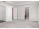 Spacious main bedroom featuring carpeted floors, base molding, a tray ceiling, and ensuite bathroom at , Kissimmee, FL 34758