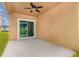 Cozy covered patio featuring a ceiling fan and a sliding glass door leading to the backyard at , Kissimmee, FL 34758