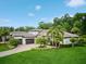 Exterior of a home with a three-car garage, a paver driveway, a verdant lawn, and mature landscaping at 2242 Soaring Eagle Pl, Lake Mary, FL 32746