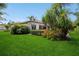 Expansive backyard featuring a well-manicured lawn, lush landscaping, and a tranquil view at 2242 Soaring Eagle Pl, Lake Mary, FL 32746