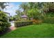 Lush green backyard with a pool, tropical landscaping, and ample space for outdoor activities at 2242 Soaring Eagle Pl, Lake Mary, FL 32746