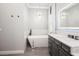 An elegant bathroom features a soaking tub, a chandelier, and a single sink vanity at 2242 Soaring Eagle Pl, Lake Mary, FL 32746