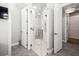 A spacious shower with glass doors has white tile and white hexagon patterned floors at 2242 Soaring Eagle Pl, Lake Mary, FL 32746