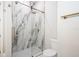 Bathroom featuring glass shower with marble-look tile, brushed gold fixtures, and tiled floor at 2242 Soaring Eagle Pl, Lake Mary, FL 32746