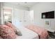 Bright bedroom featuring a comfortable bed, closet, television, and an ensuite bathroom at 2242 Soaring Eagle Pl, Lake Mary, FL 32746