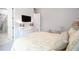 Bedroom boasts a decorative bed, flat-screen TV, ensuite bathroom, and white woven dresser at 2242 Soaring Eagle Pl, Lake Mary, FL 32746