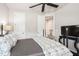 Neutral bedroom featuring a wrought iron bed, television, and view of an ensuite bathroom at 2242 Soaring Eagle Pl, Lake Mary, FL 32746