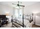 Inviting bedroom featuring a wrought iron bed, decorative lamps, and a light filled window at 2242 Soaring Eagle Pl, Lake Mary, FL 32746